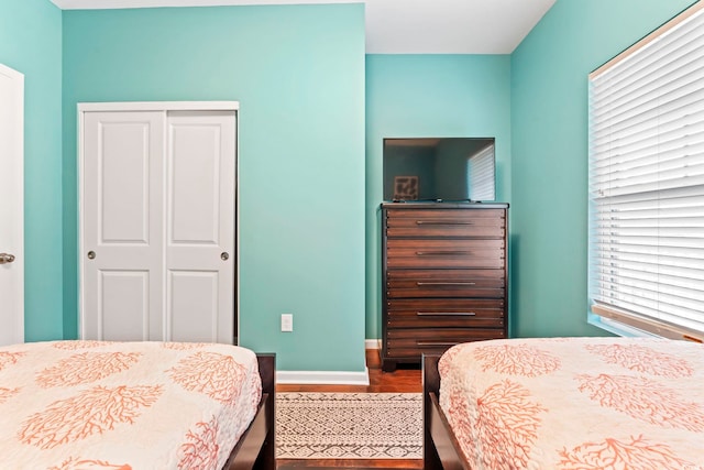 6253 Catalina Dr Unit 733, North Myrtle Beach, SC 29582 - bedroom with a closet, dark wood-type flooring, and baseboards