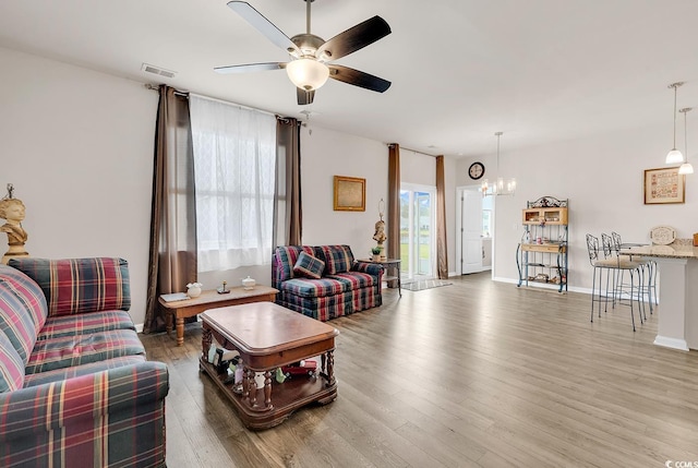 1170 Maxwell Dr, Little River, SC 29566 - living room with wood finished floors, a chandelier, a ceiling fan, and baseboards