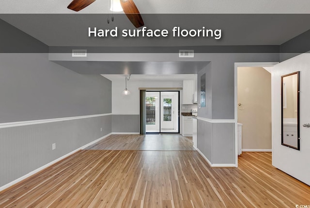 633 Sparrow Dr Unit B, Surfside Beach, SC 29575 - unfurnished living room featuring light wood-type flooring, a ceiling fan, and baseboards