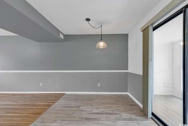 633 Sparrow Dr Unit B, Surfside Beach, SC 29575 - unfurnished dining area featuring wood finished floors, wainscoting, and baseboards
