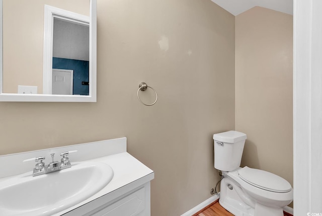 633 Sparrow Dr Unit B, Surfside Beach, SC 29575 - bathroom with toilet, vanity, baseboards, and vaulted ceiling