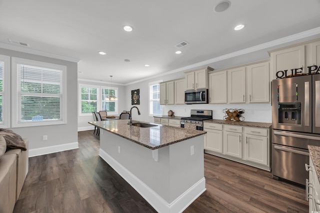 340 Scottsdale Ct, Murrells Inlet, SC 29576 - kitchen with stainless steel appliances, a sink, ornamental molding, dark stone counters, and tasteful backsplash
