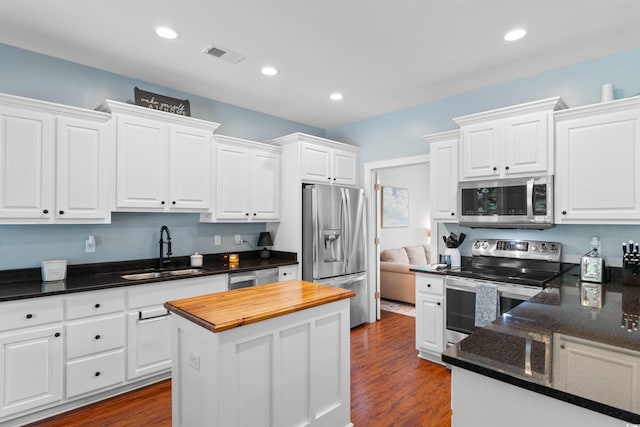 116 Chapel Ridge Cir, Myrtle Beach, SC 29588 - kitchen with appliances with stainless steel finishes, a sink, white cabinets, dark wood-style flooring, and recessed lighting