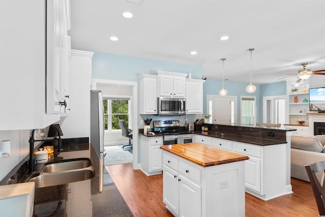 116 Chapel Ridge Cir, Myrtle Beach, SC 29588 - kitchen with appliances with stainless steel finishes, a peninsula, open floor plan, wooden counters, and light wood-type flooring