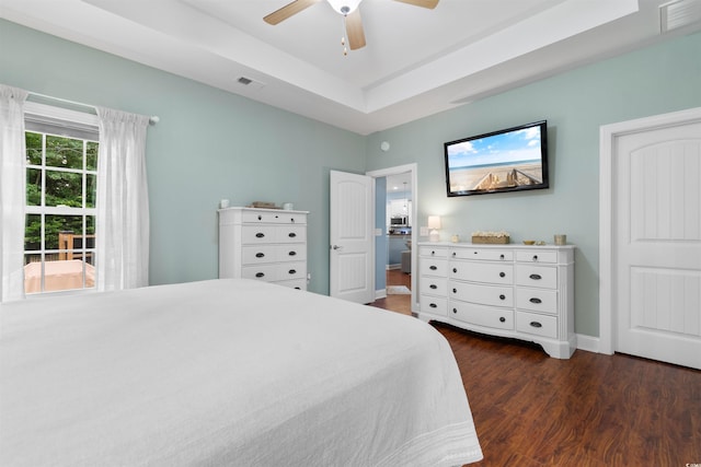116 Chapel Ridge Cir, Myrtle Beach, SC 29588 - bedroom featuring dark wood-type flooring, baseboards, ceiling fan, and a raised ceiling
