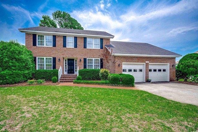 3334 Cedar Creek Run, Little River, SC 29566 - colonial home with concrete driveway, a garage, a front yard, and brick siding