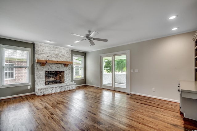 3334 Cedar Creek Run, Little River, SC 29566 - unfurnished living room featuring a ceiling fan, crown molding, wood finished floors, a fireplace, and baseboards