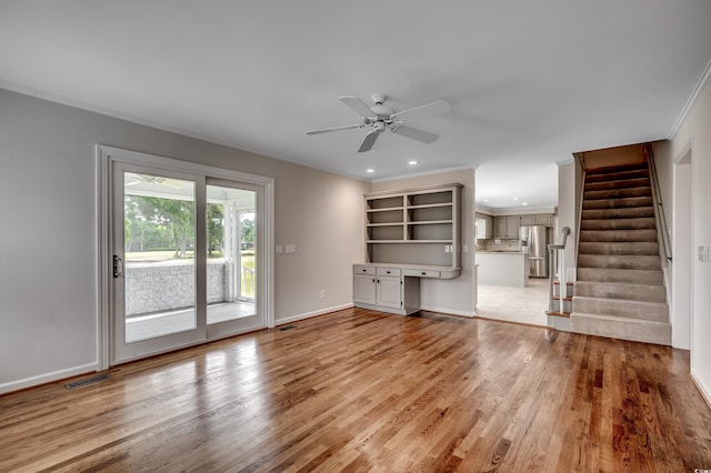 3334 Cedar Creek Run, Little River, SC 29566 - unfurnished living room with ornamental molding, light wood-type flooring, ceiling fan, stairs, and baseboards