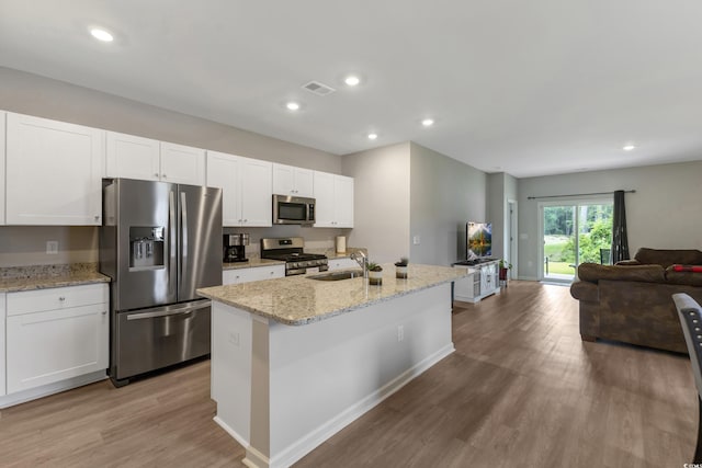 120 Carolina Lakes Blvd, Myrtle Beach, SC 29588 - kitchen featuring stainless steel appliances, a sink, open floor plan, light wood-style floors, and white cabinetry