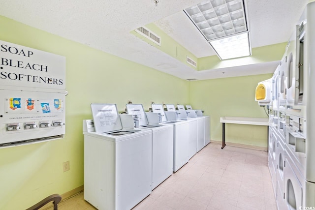 3000 N Ocean Blvd N Unit 531, Myrtle Beach, SC 29577 - community laundry with estacked washer and dryer, washing machine and clothes dryer, baseboards, light tile patterned flooring, and a textured ceiling