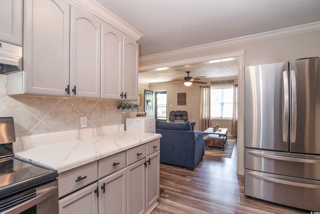 2510 Redwood St, Georgetown, SC 29440 - kitchen featuring stainless steel appliances, ornamental molding, wood finished floors, tasteful backsplash, and range hood