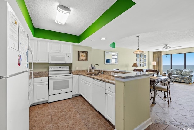 4103 N Ocean Blvd N Unit 204, North Myrtle Beach, SC 29582 - kitchen with white appliances, a sink, a textured ceiling, open floor plan, and a peninsula