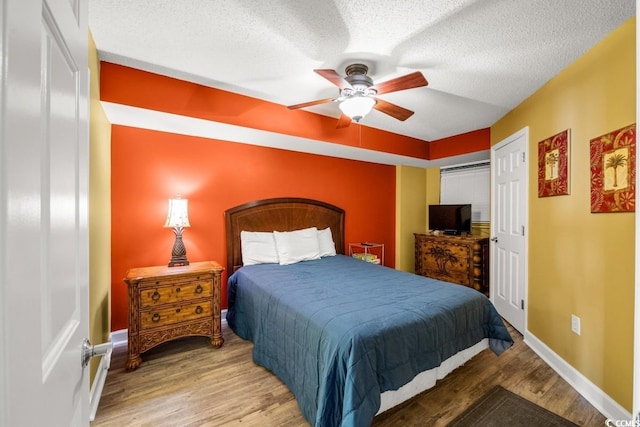 4103 N Ocean Blvd N Unit 204, North Myrtle Beach, SC 29582 - bedroom featuring wood finished floors, baseboards, a textured ceiling, and ceiling fan