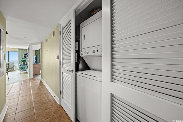 4103 N Ocean Blvd N Unit 204, North Myrtle Beach, SC 29582 - laundry room with estacked washer and dryer, tile patterned floors, and baseboards