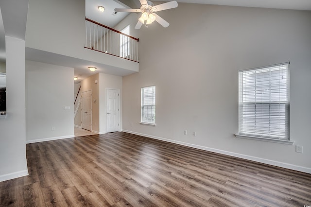 422 S Poplar Dr, Surfside Beach, SC 29575 - unfurnished living room with high vaulted ceiling, ceiling fan, wood finished floors, and baseboards