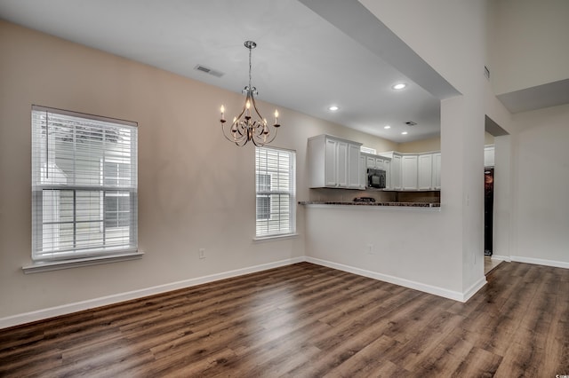 422 S Poplar Dr, Surfside Beach, SC 29575 - kitchen featuring black microwave, dark wood-style flooring, a chandelier, baseboards, and pendant lighting