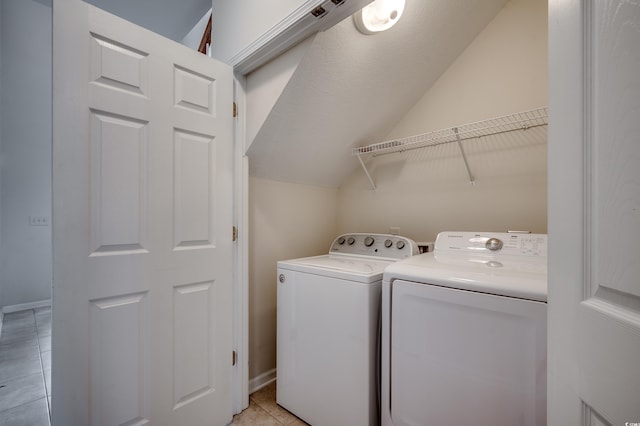 422 S Poplar Dr, Surfside Beach, SC 29575 - washroom with washer and clothes dryer, light tile patterned flooring, and baseboards