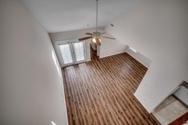 422 S Poplar Dr, Surfside Beach, SC 29575 - unfurnished living room featuring lofted ceiling, wood finished floors, ceiling fan, and baseboards