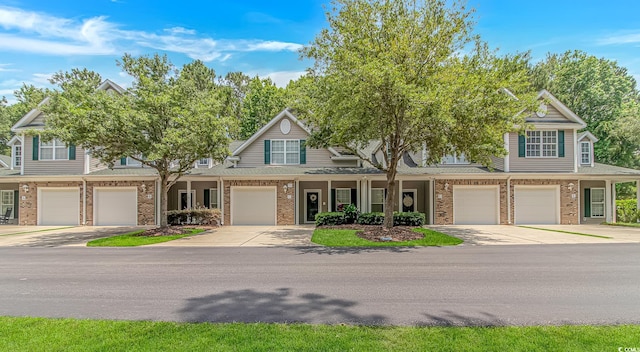 751 Painted Bunting Dr Unit E, Murrells Inlet, SC 29576 - view of front of property featuring brick siding, a garage, driveway, and covered porch