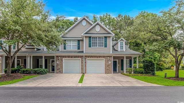751 Painted Bunting Dr Unit E, Murrells Inlet, SC 29576 - view of front of property with driveway, brick siding, an attached garage, a porch, and a shingled roof