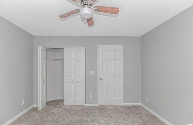 751 Painted Bunting Dr Unit E, Murrells Inlet, SC 29576 - unfurnished bedroom with light carpet, a closet, baseboards, and ceiling fan