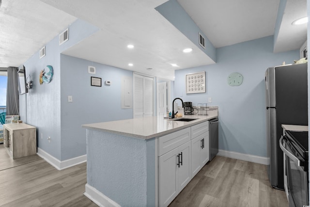 9550 Shore Dr Unit 529, Myrtle Beach, SC 29572 - kitchen featuring range with electric cooktop, dishwasher, a sink, a peninsula, and baseboards