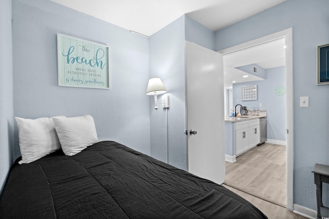 9550 Shore Dr Unit 529, Myrtle Beach, SC 29572 - bedroom with light wood-style floors, a sink, and baseboards