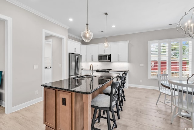 8469 Cape Dutch Loop, Myrtle Beach, SC 29572 - kitchen featuring appliances with stainless steel finishes, a sink, baseboards, ornamental molding, and decorative backsplash