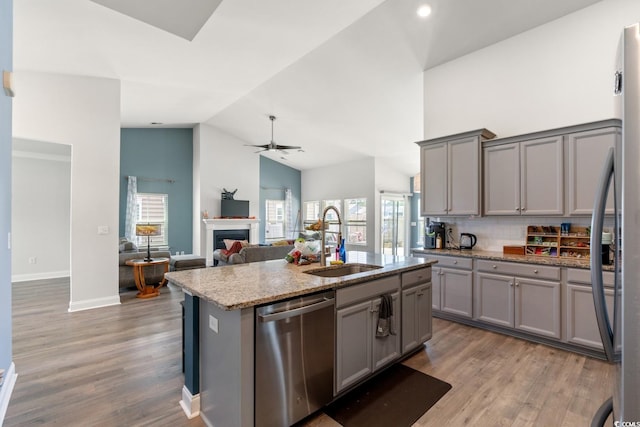 720 Little Fawn Way, Myrtle Beach, SC 29579 - kitchen with stainless steel appliances, a sink, gray cabinets, high vaulted ceiling, and a fireplace