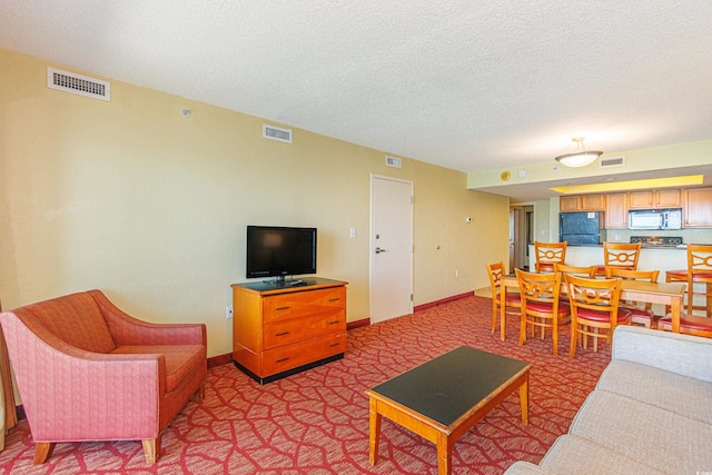 504 N Ocean Blvd Unit 1804A/B, Myrtle Beach, SC 29577 - living area featuring a textured ceiling, light carpet, and baseboards