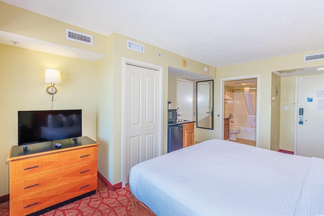 504 N Ocean Blvd Unit 1804A/B, Myrtle Beach, SC 29577 - bedroom featuring a closet, baseboards, a textured ceiling, and connected bathroom