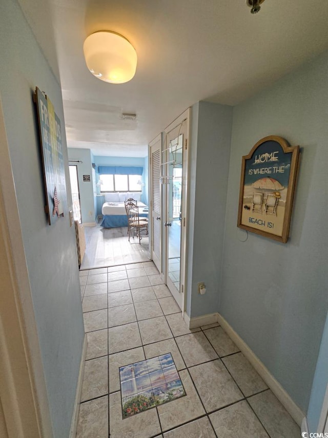 1605 S Ocean Blvd S Unit 105, Myrtle Beach, SC 29577 - hallway featuring light tile patterned floors, baseboards, and french doors
