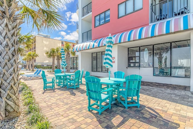 1605 S Ocean Blvd S Unit 105, Myrtle Beach, SC 29577 - view of patio featuring a balcony and outdoor dining space