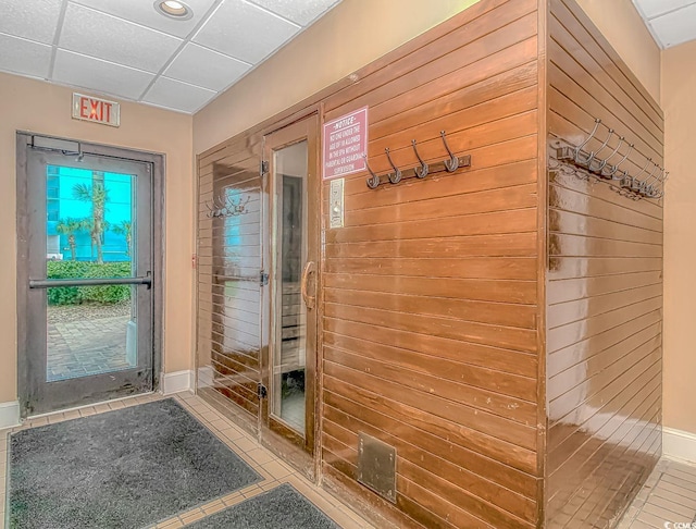1605 S Ocean Blvd S Unit 105, Myrtle Beach, SC 29577 - doorway featuring tile patterned flooring, a paneled ceiling, wooden walls, and recessed lighting