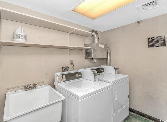 1605 S Ocean Blvd S Unit 105, Myrtle Beach, SC 29577 - laundry area with washing machine and clothes dryer and a sink