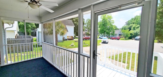 302 Silver Fox Trl, Myrtle Beach, SC 29588 - unfurnished sunroom featuring a ceiling fan, plenty of natural light, and a residential view