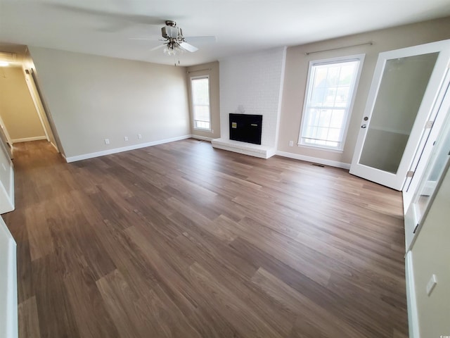302 Silver Fox Trl, Myrtle Beach, SC 29588 - unfurnished living room with a ceiling fan, baseboards, wood finished floors, and a brick fireplace