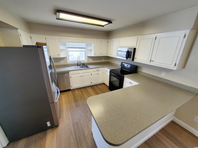 302 Silver Fox Trl, Myrtle Beach, SC 29588 - kitchen featuring stainless steel appliances, dark wood-style floors, a peninsula, a sink, and white cabinets