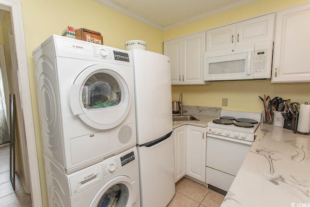 4516 Seaview St Unit 137, North Myrtle Beach, SC 29582 - laundry area with estacked washer and dryer, light tile patterned flooring, and ornamental molding