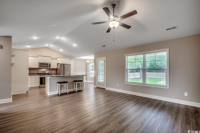 3129 Slade Dr, Conway, SC 29526 - unfurnished living room with vaulted ceiling, a chandelier, dark wood-style flooring, a ceiling fan, and baseboards