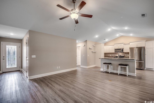 3129 Slade Dr, Conway, SC 29526 - unfurnished living room featuring ceiling fan, lofted ceiling, wood finished floors, and baseboards