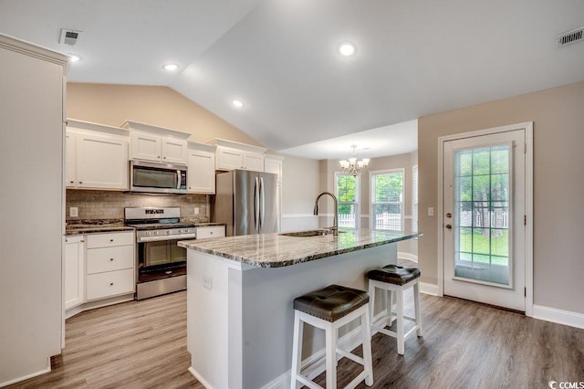 3129 Slade Dr, Conway, SC 29526 - kitchen with appliances with stainless steel finishes, a sink, a chandelier, vaulted ceiling, and white cabinetry