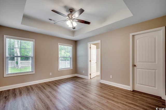 3129 Slade Dr, Conway, SC 29526 - spare room with a raised ceiling, wood finished floors, ceiling fan, and baseboards
