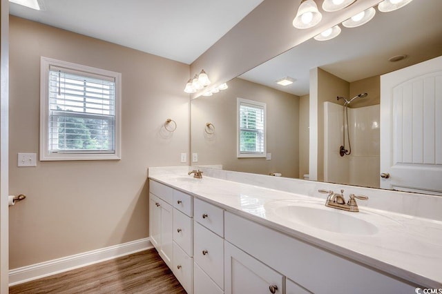 3129 Slade Dr, Conway, SC 29526 - bathroom with double vanity, baseboards, a shower, wood finished floors, and toilet