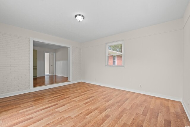 203 Longwood Ln, Conway, SC 29527 - spare room featuring light wood finished floors, baseboards, and brick wall