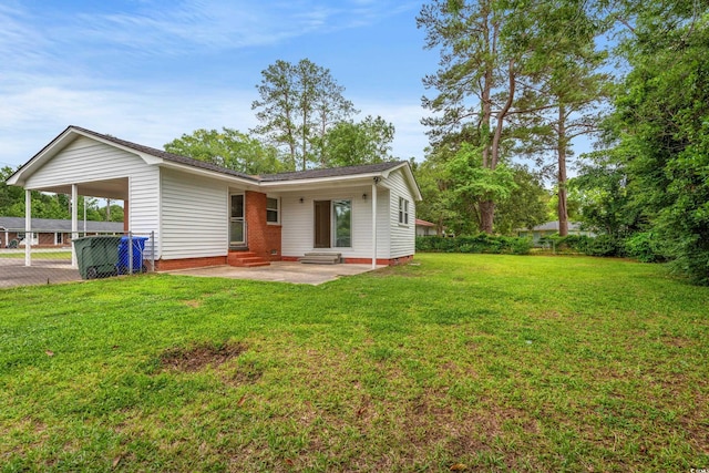 203 Longwood Ln, Conway, SC 29527 - back of house featuring entry steps, a carport, and a lawn