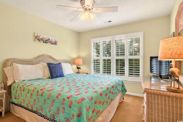 6 Indigo Ct, Ocean Isle Beach, NC 28469 - bedroom with light colored carpet, a textured ceiling, a ceiling fan, and baseboards
