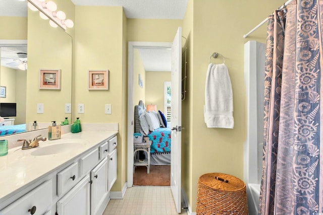 6 Indigo Ct, Ocean Isle Beach, NC 28469 - ensuite bathroom featuring vanity, ceiling fan, shower / bathtub combination with curtain, and a textured ceiling