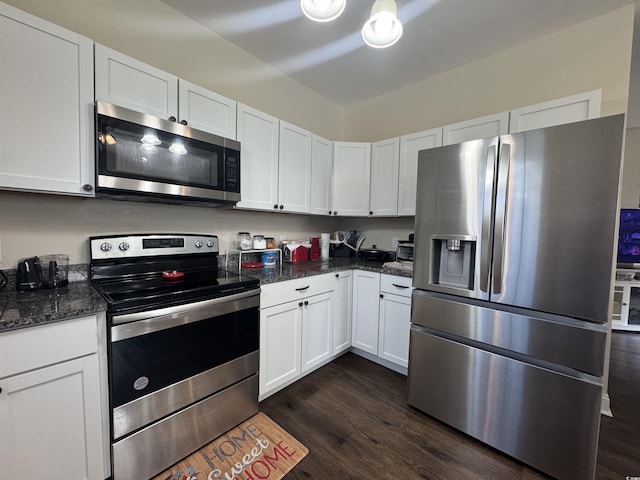 304 S Magnolia Ave, Andrews, SC 29510 - kitchen with stainless steel appliances, white cabinetry, dark wood-style flooring, and dark stone counters