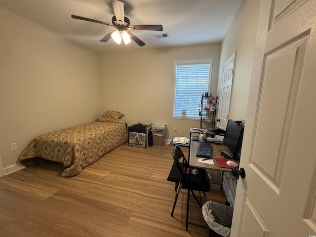 304 S Magnolia Ave, Andrews, SC 29510 - bedroom with wood finished floors, a desk, baseboards, and ceiling fan